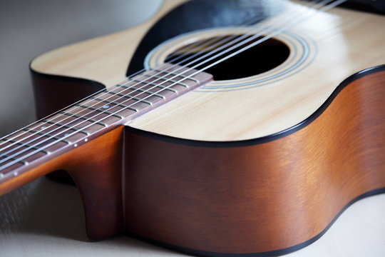 closeup of body , pickguard and soundhole of acoustic guitar  background