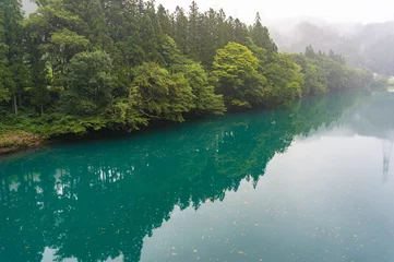 Zelfklevend Fotobehang Nature background landscape of turquoise lake in forest © Olga K