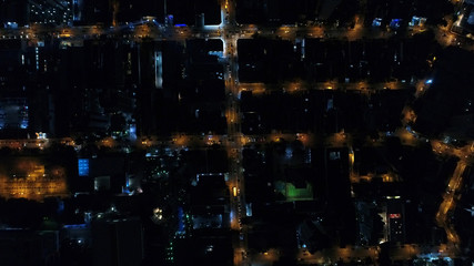 Top View of Intersection, Rooftops and illuminated streets in Sao Paulo, Brazil