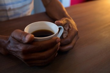 Close up of man holding coffee cup