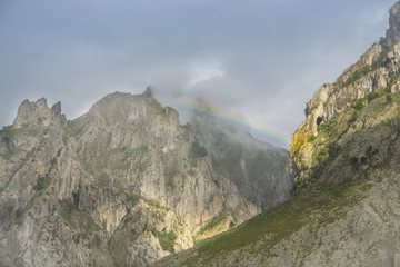 Beautiful landscape of the mountains in Picos de Europa in Spain; hiking trail in foggy and cloudy summer day