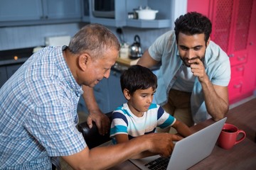 High angle view of father and grandfather looking at boy