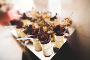 Delicious sweets on wedding candy buffet with desserts, cupcakes