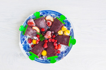 Homemade organic summer fruit ice cream on plate with fresh fruits