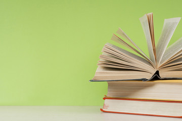 Open book, hardback books on wooden table. Education background. Back to school. Copy space for text.