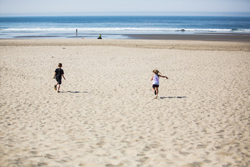 Children running toward the beach on vacation