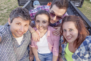 Happy group of young friends toasting with beer