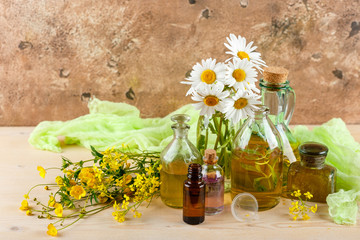 Obraz na płótnie Canvas Essential oils and wild flowers