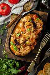 Chakhokhbili - traditional Georgian dish. Stewed chicken with tomato, onion, garlic, pepper and cilantro. Selective focus. Top view.