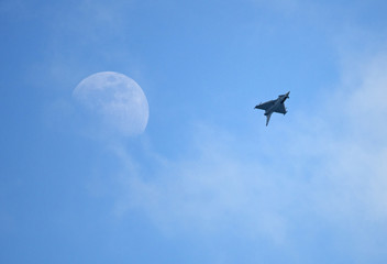 Eurofighter Typhoon upside down with moon in background
