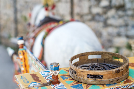 Sicilian cart with white horse. Carries typical Sicilian objects