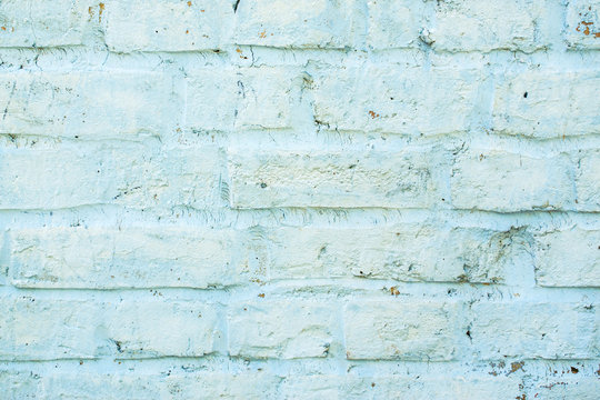 Blue old brick wall with paint, background texture close up