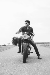 Young biker with his motorcycle