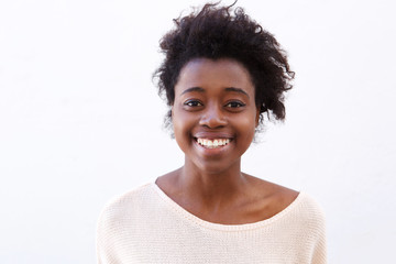 Close up young african american woman smiling against white background