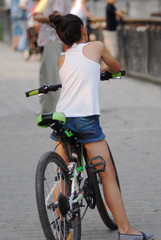 The girl on a bicycle from the back