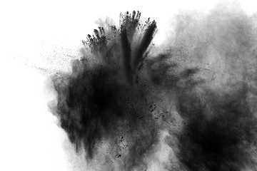 abstract black powder splatted on white background,Freeze motion of black powder exploding.
