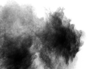 abstract black powder splatted on white background,Freeze motion of black powder exploding.