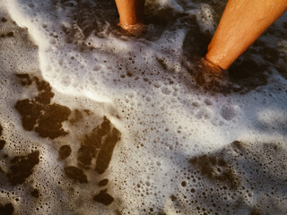 Close up top view human feet on natural ocean sandy beach vacation lifestyle background