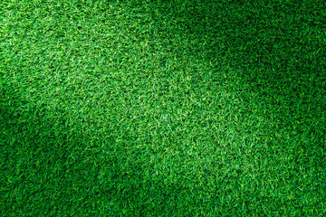Obraz premium Artificial green grass texture for golf course, soccer field or sports background concept design.