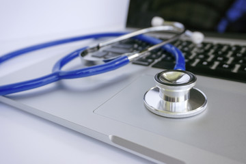 Stethoscope Lying on Top of Laptop Computer