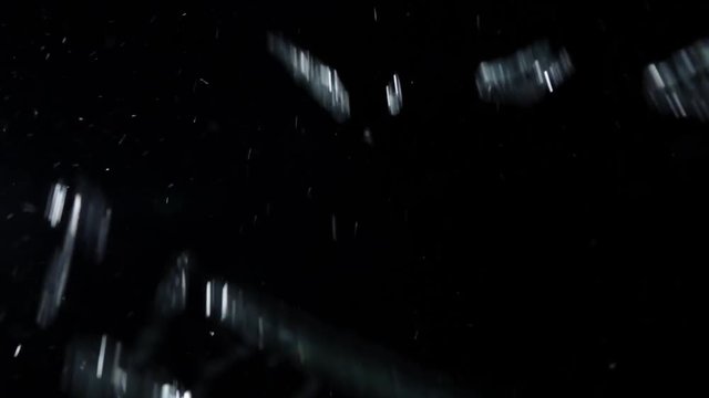 Real glass breaking at camera. Slow motion.