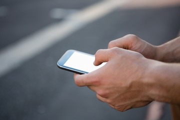 Cropped hands of man using phone