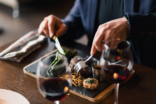 Man Is Eating In A Restaurant And Enjoying Delicious Food