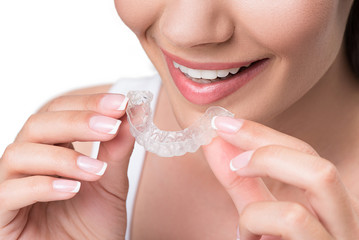 Joyful young woman undergoing clear-aligner treatment