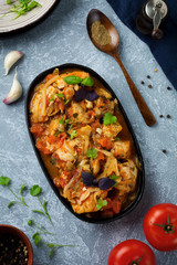 Chakhokhbili - traditional Georgian dish. Stewed chicken with tomato, onion, garlic, pepper and cilantro. Selective focus. Top view.