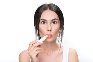 Shocked girl doing healthy facial make-up