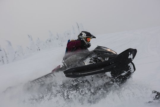 Man riding snowmobile in snowy alps