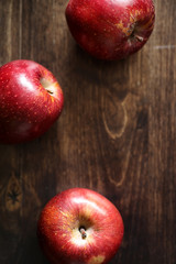 Red fresh apple on a wooden table