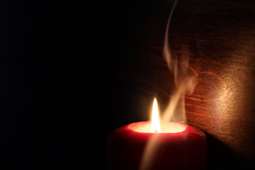 Burning candle flame in the dark