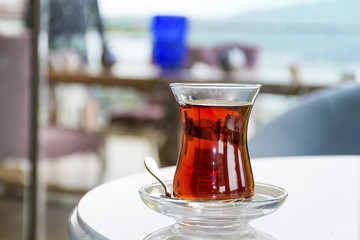 Turkish tea with authentic glass cup on a table in a coffee bar