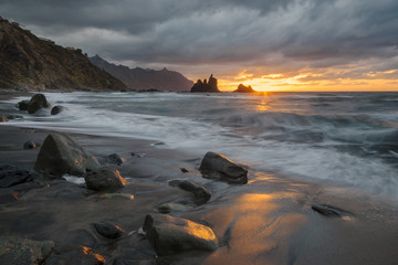 Fototapeta na wymiar Sunset over oceanic, rocky shore