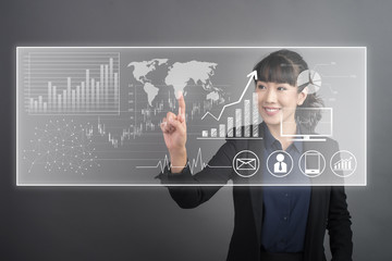 Beautiful Business Woman touching finance graph technology on virtual screen