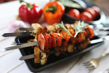 Kebab cooked on metal skewers with vegetables
