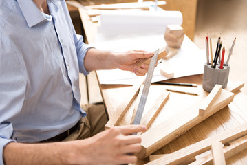 Woodworker preparing materials to create end product at workplace