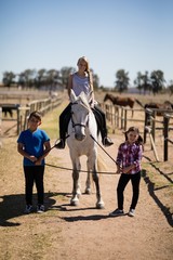 Obraz premium Kids riding a horse in the ranch