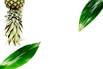Pineapple and leaves on white background top view copyspace