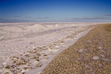 Icy Beach:  Frozen waves of ice and snow stand just off shore on Green Bay in Wisconsin.