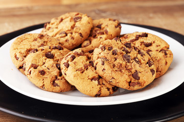 Chocolate cookies on wooden table. Chocolate chip cookies shot