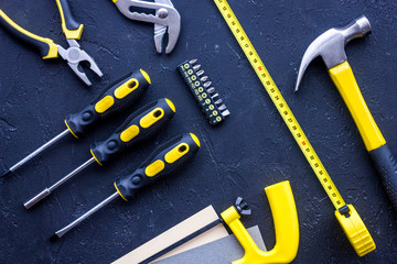 Tools for repairing on black stone desk background top view