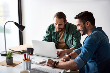 Busy smiling coworkers working together