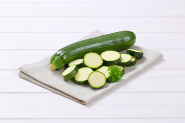 whole and sliced green zucchini