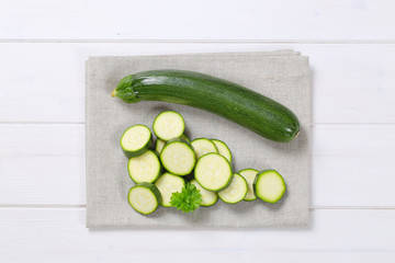 whole and sliced green zucchini