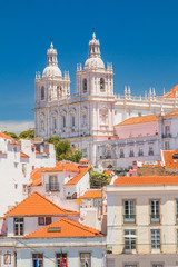 Obraz premium Aerial scenic view of central Lisbon Portugal with red tile roofs and monastery Igreja Sao Vicente de Fora 