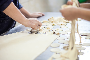 Obraz na płótnie Canvas cutting dough for dumplings