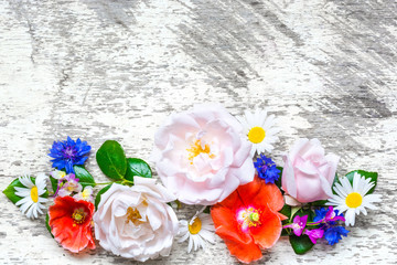 Festive flower composition on the white wooden background. top view