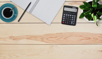 Creative design mockup set of workspace desk. Top view of home desktop. Calculator, mug with coffee or tea, pot with flower, notebook and pen laying on wooden table. Calculating figures at home